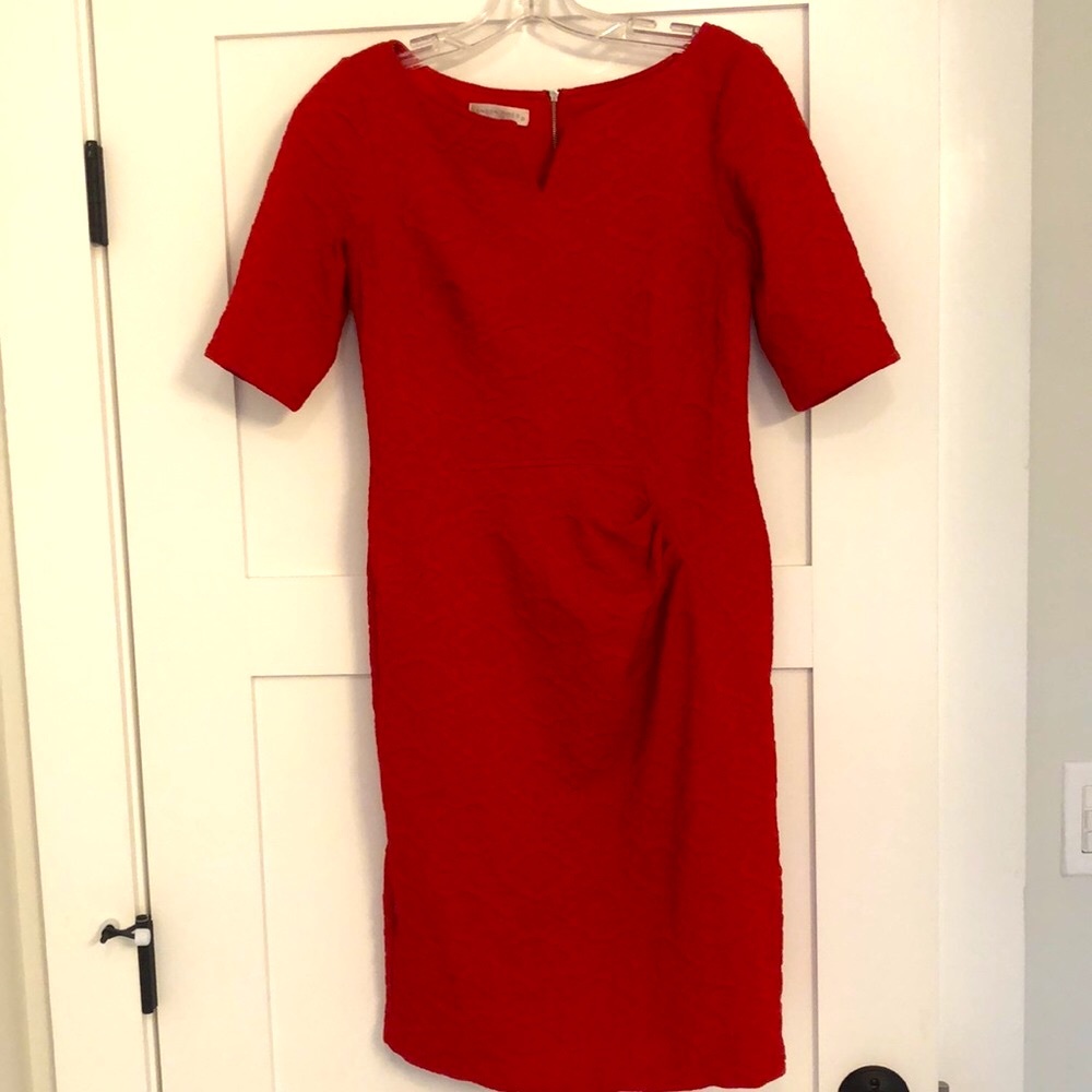 Red dress with side cinching and stylish neckline.